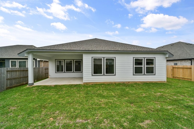 rear view of house with a lawn and a patio