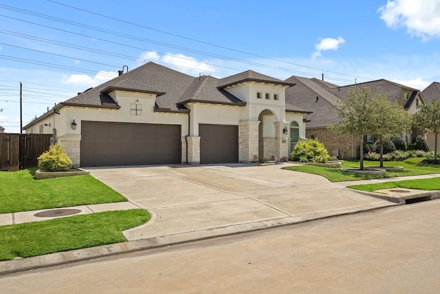 view of front of property featuring a garage and a front lawn