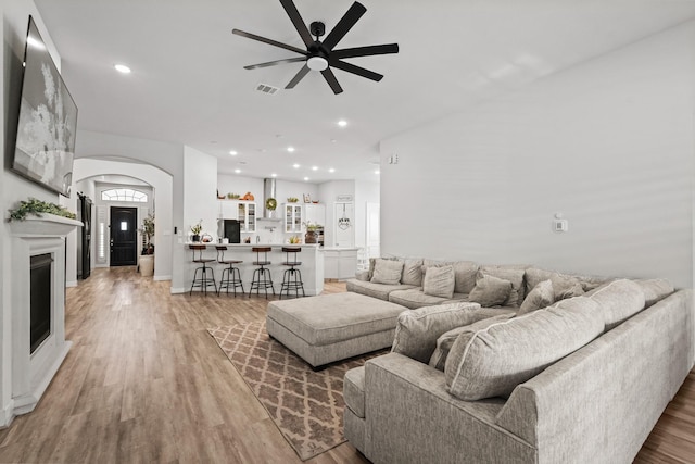 living room with ceiling fan and hardwood / wood-style floors