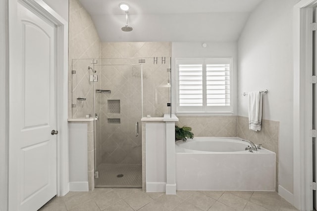 bathroom with tile patterned floors, lofted ceiling, and independent shower and bath