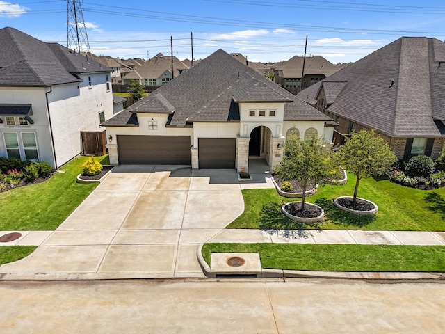 french country style house with a front yard and a garage