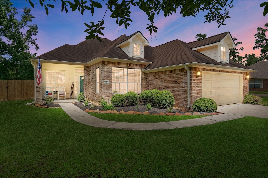 view of front facade with a lawn and a garage