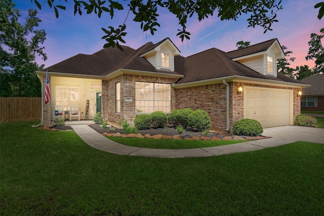 view of front facade with a lawn and a garage