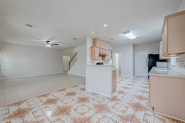 kitchen featuring decorative backsplash, ceiling fan, sink, light brown cabinets, and light tile patterned floors