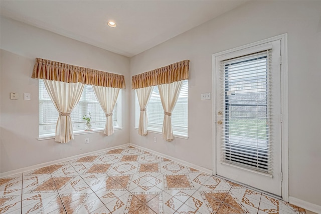 doorway to outside with light tile patterned floors