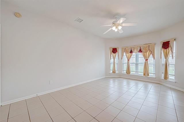 empty room featuring ceiling fan and light tile patterned flooring