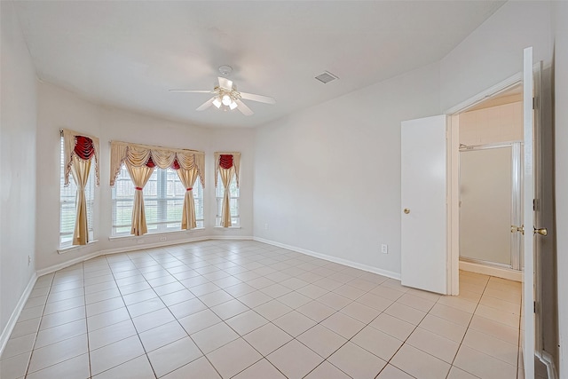 unfurnished room featuring ceiling fan and light tile patterned floors