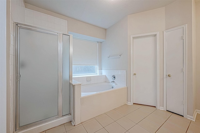 bathroom with tile patterned flooring, a textured ceiling, and plus walk in shower