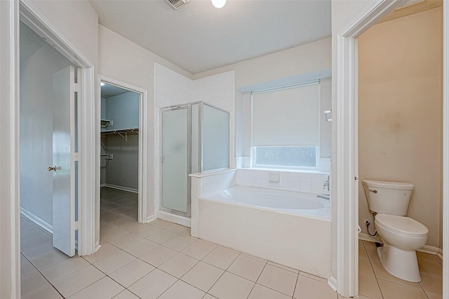 bathroom featuring separate shower and tub, tile patterned flooring, and toilet