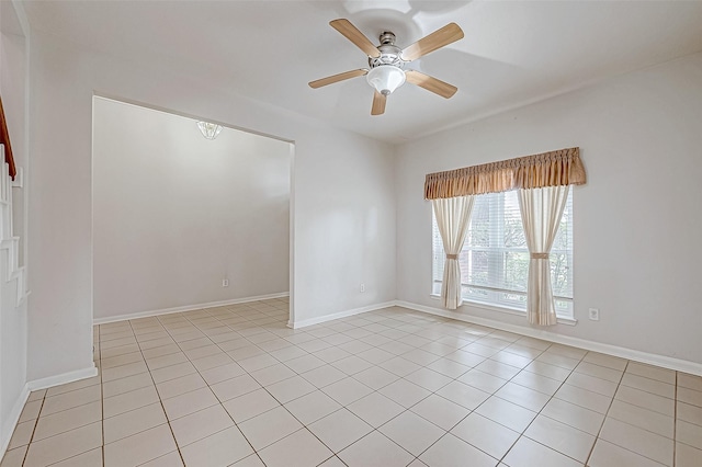 spare room with ceiling fan and light tile patterned floors