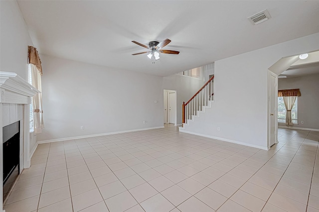 unfurnished living room with ceiling fan and light tile patterned floors