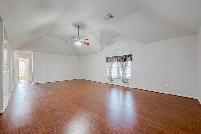 spare room featuring wood-type flooring, vaulted ceiling, and ceiling fan