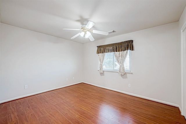 unfurnished room featuring hardwood / wood-style floors and ceiling fan