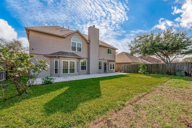 rear view of property with a yard and a patio