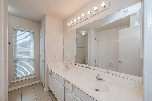 full bathroom with tile patterned floors, vanity, toilet, and tiled shower / bath