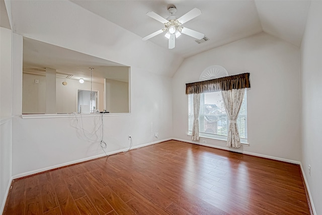 empty room featuring ceiling fan, hardwood / wood-style floors, and vaulted ceiling