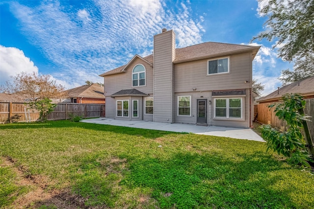 rear view of house with a patio area and a lawn