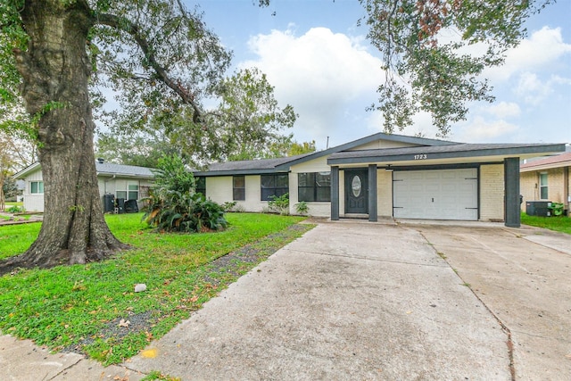 single story home with a front yard and a garage