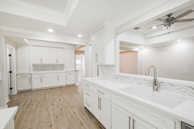 kitchen featuring white cabinetry, sink, crown molding, decorative backsplash, and light wood-type flooring