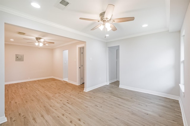 spare room featuring electric panel, crown molding, ceiling fan, and light hardwood / wood-style floors