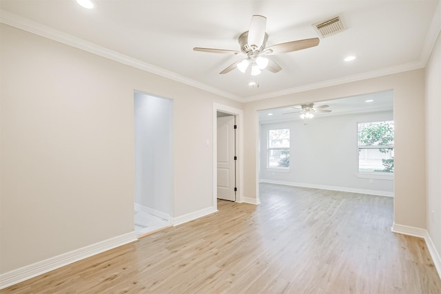 spare room featuring ceiling fan, light hardwood / wood-style floors, and crown molding