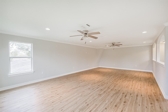 spare room featuring crown molding, light hardwood / wood-style flooring, and ceiling fan