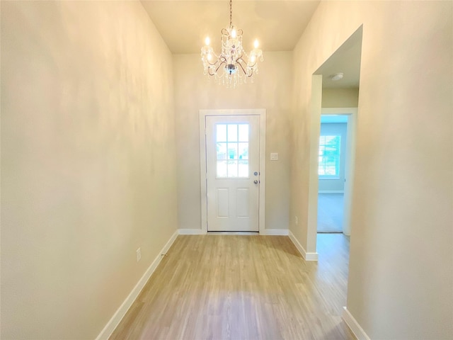 entryway with a chandelier and light hardwood / wood-style floors