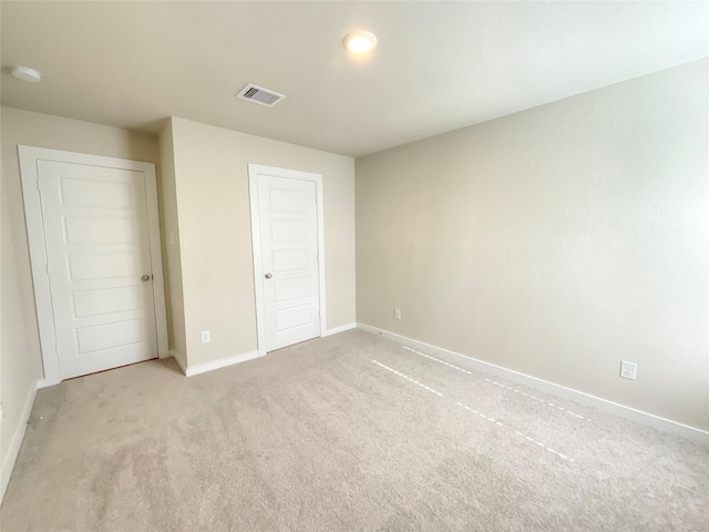 unfurnished bedroom with light carpet