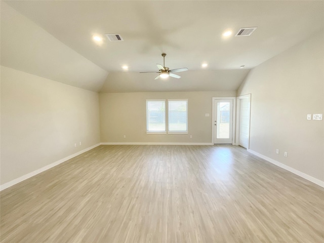 spare room featuring lofted ceiling, ceiling fan, and light wood-type flooring