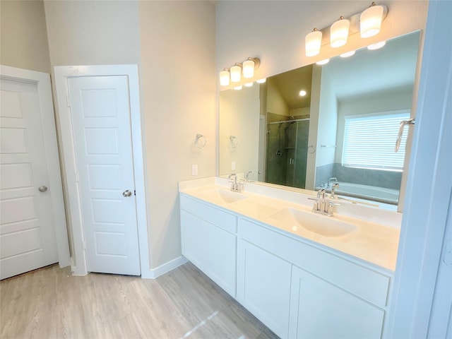 bathroom featuring vanity, independent shower and bath, and hardwood / wood-style flooring