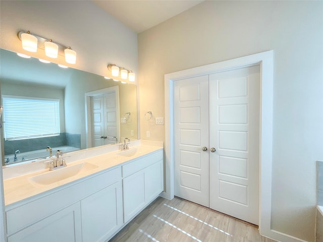 bathroom with a washtub and vanity