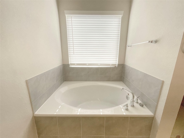 bathroom featuring tiled bath