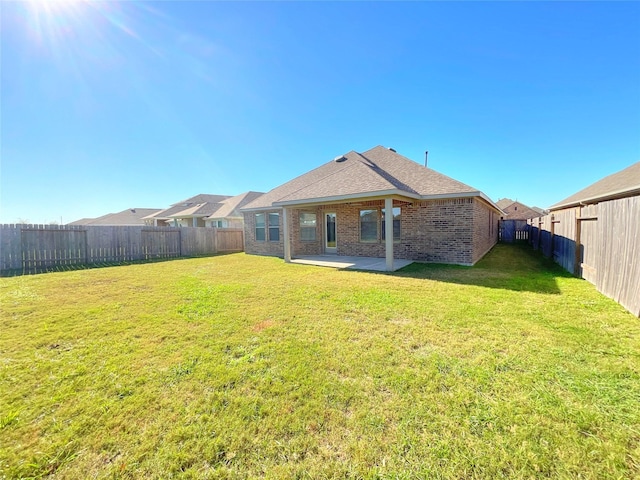 rear view of property with a patio area and a yard