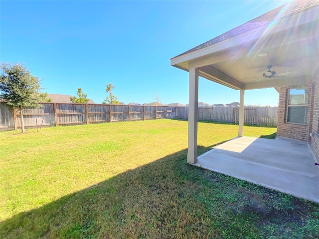 view of yard featuring ceiling fan and a patio area