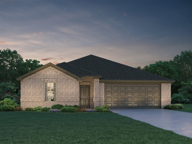 view of front of home with a lawn and a garage