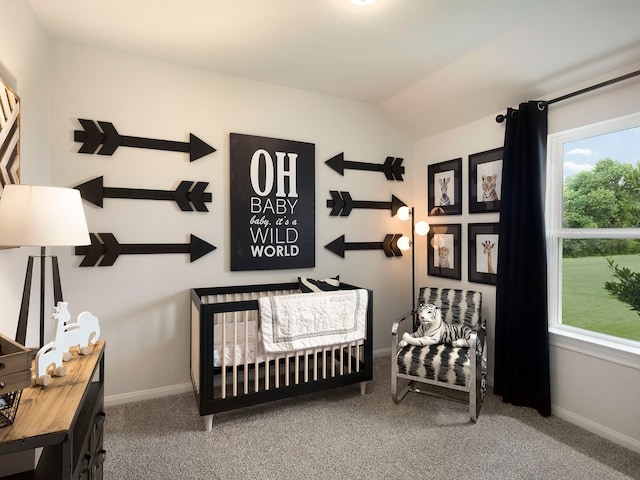 carpeted bedroom featuring lofted ceiling and a crib