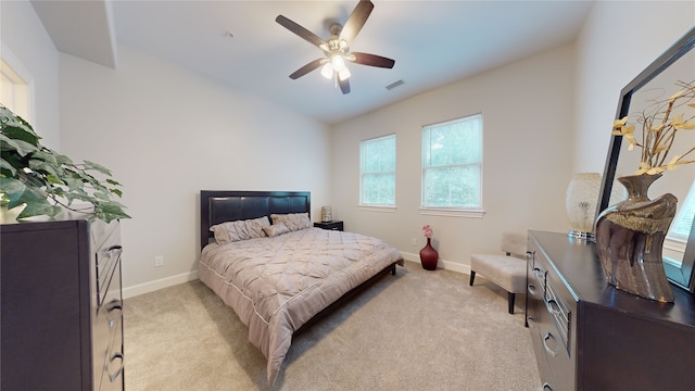 bedroom with light colored carpet and ceiling fan