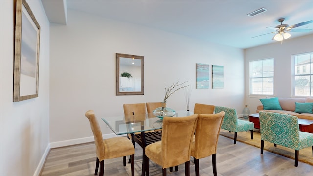 dining space featuring light hardwood / wood-style floors and ceiling fan