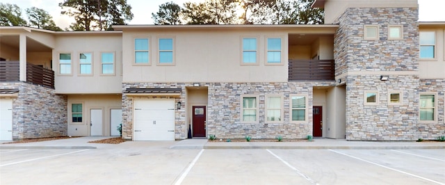 view of front facade featuring a balcony and a garage