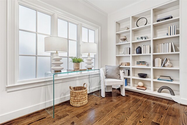 living area featuring dark hardwood / wood-style flooring and ornamental molding