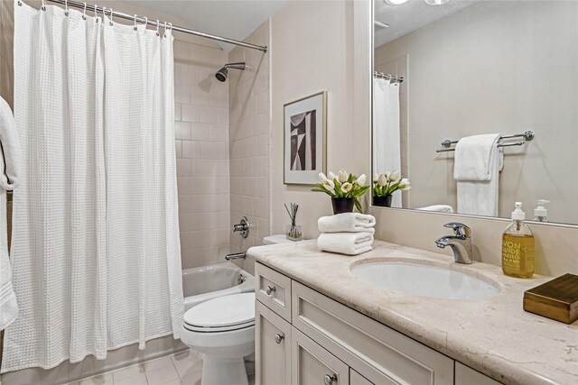 full bathroom featuring tile patterned flooring, shower / bath combo, toilet, and vanity