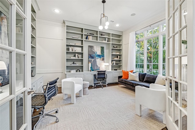 office space featuring a notable chandelier, french doors, built in features, and ornamental molding