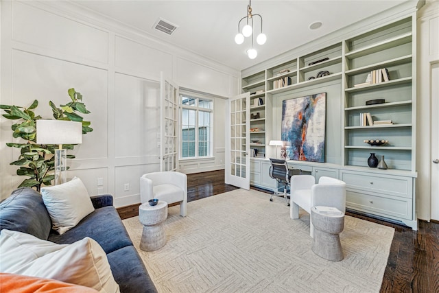 office featuring built in features, wood-type flooring, ornamental molding, and french doors