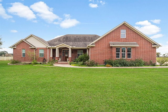 view of front facade with covered porch and a front lawn