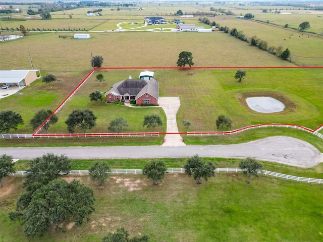 birds eye view of property with a rural view