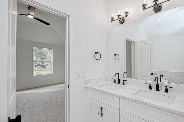 bathroom with vanity and lofted ceiling