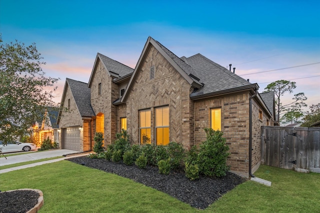 view of front facade featuring a garage and a yard