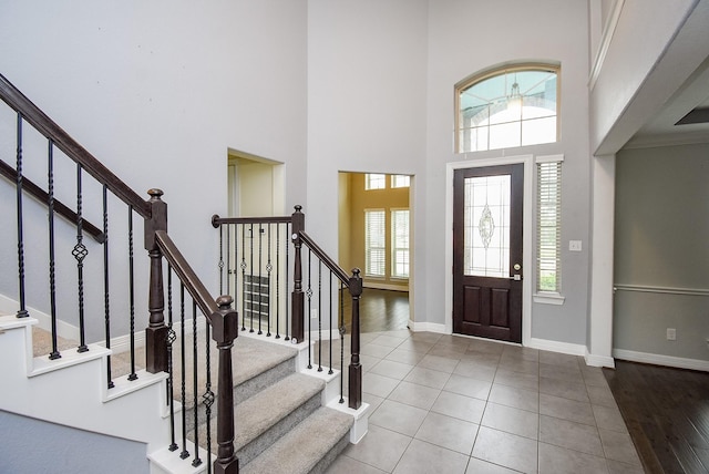 entryway featuring tile patterned floors and a high ceiling