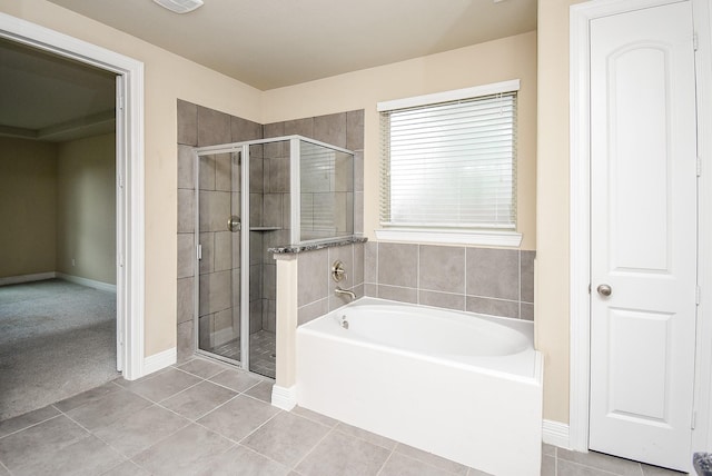 bathroom featuring tile patterned flooring and shower with separate bathtub