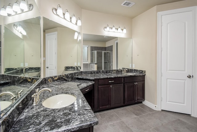 bathroom featuring tile patterned floors, vanity, and walk in shower